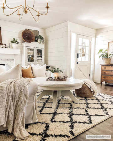 Farmhouse living room with a beige and charcoal Wallagrass Moroccan Shag Rug, white sofa, and round coffee table. Roomscene-Rectangle
