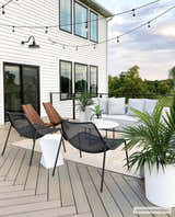 Outdoor patio scene with a beige Galston Outdoor Rug, modern seating, and string lights. Farmhouse style. Roomscene-Rectangle
