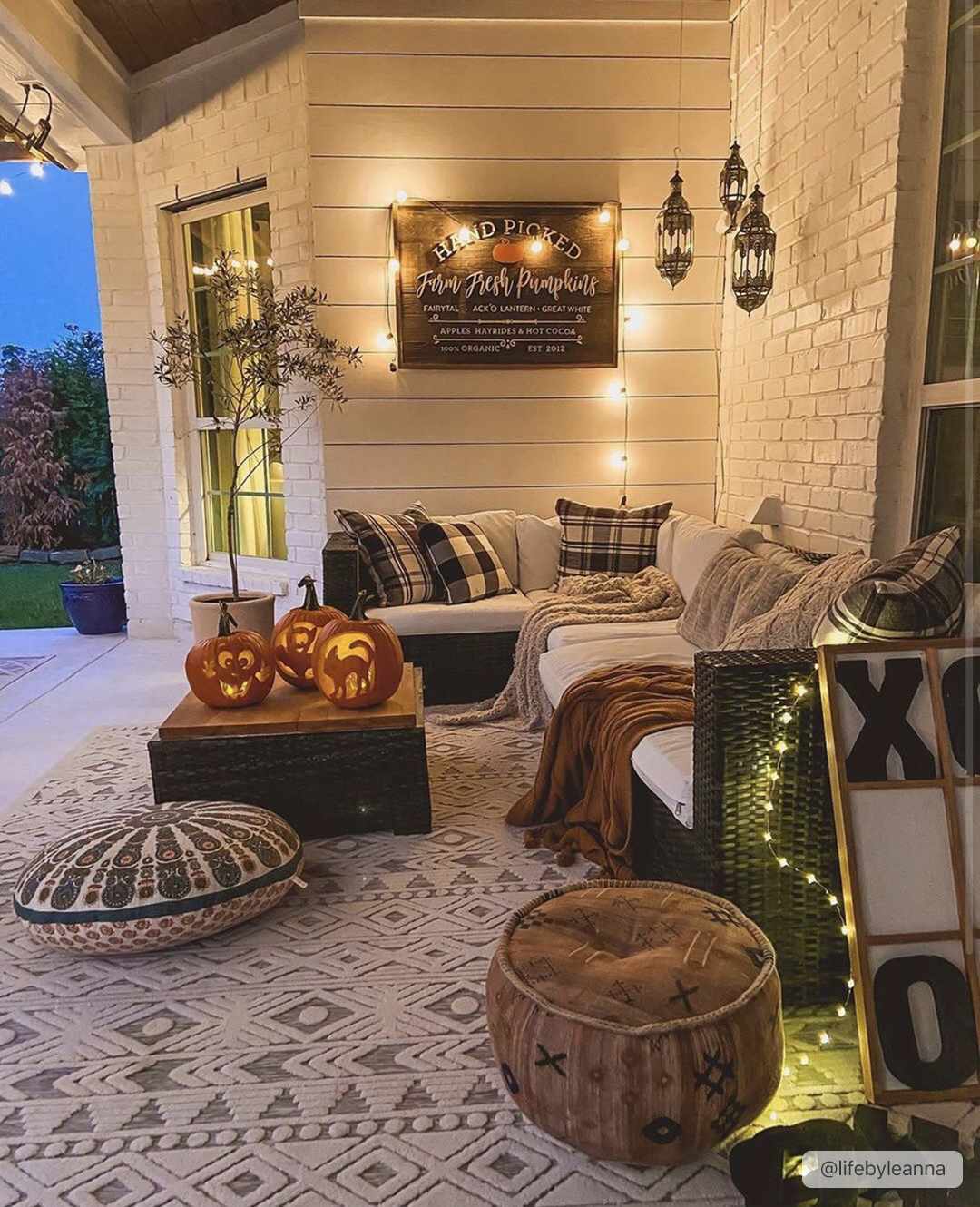 Fall porch scene with Mirani 3D Outdoor Area Rug, pumpkins, cozy seating, and string lights. Charcoal and light beige rug. Roomscene-Rectangle