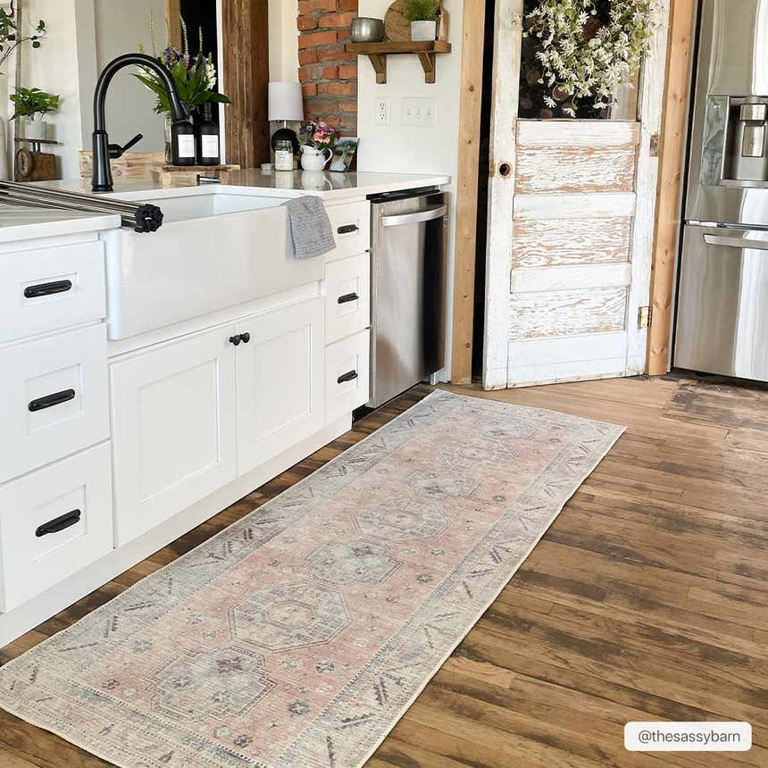 Farmhouse kitchen with white cabinets and Morcott Peach Washable Area Rug runner on wood floor. Roomscene-Runner