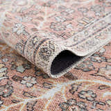 Close-up of the Flat Pile Urpi Red Washable Rug showing its traditional Persian pattern, flat weave, and red, beige, and cream colors. Fold