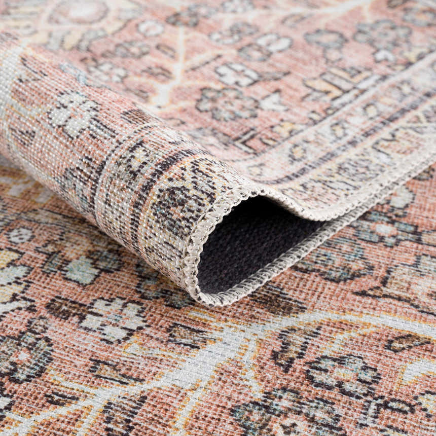 Close-up of the Flat Pile Urpi Red Washable Rug showing its traditional Persian pattern, flat weave, and red, beige, and cream colors. Fold