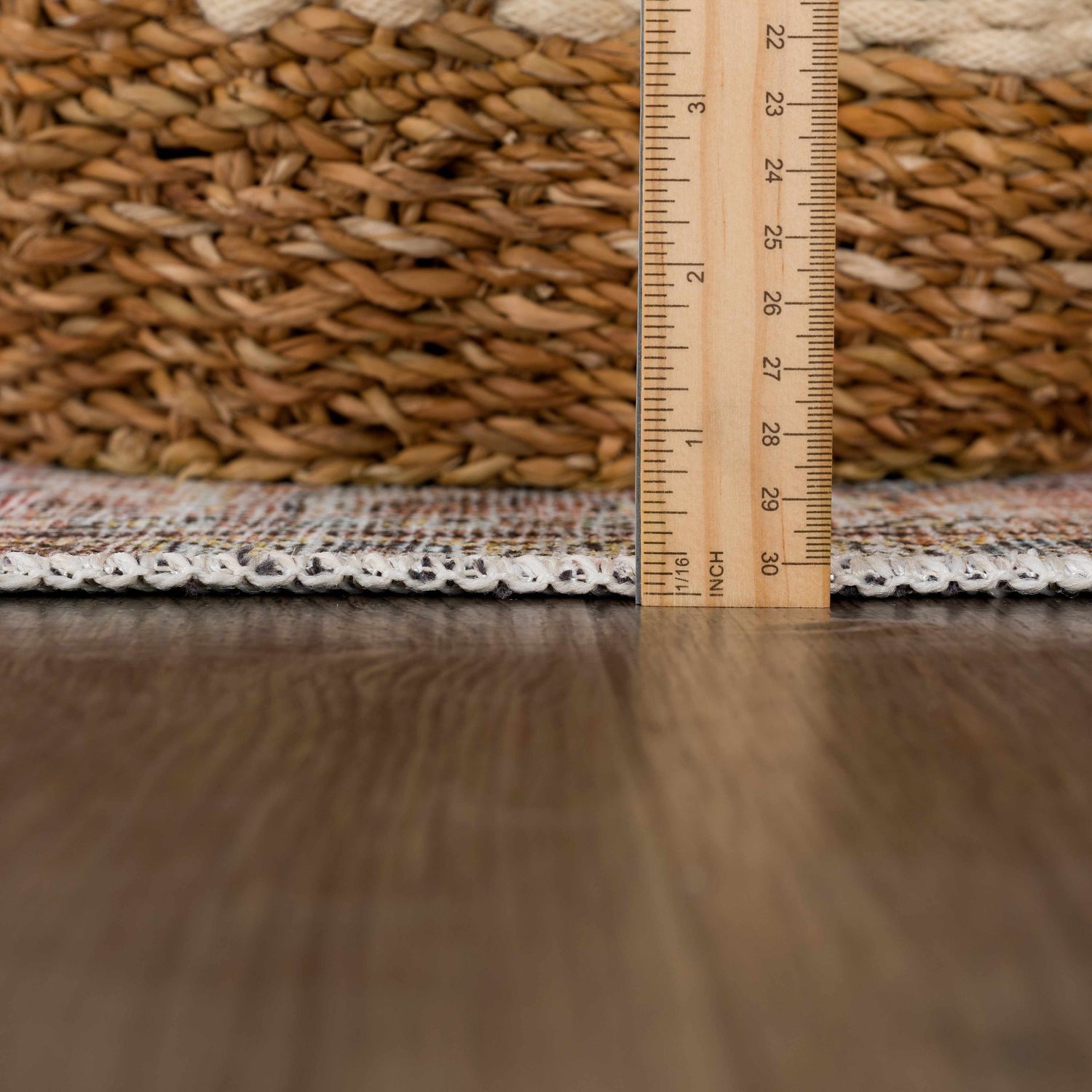 Close-up of Flat Pile Urpi Red Washable Rug showing its flat construction, edge binding, and multi-color vintage pattern. Pile
