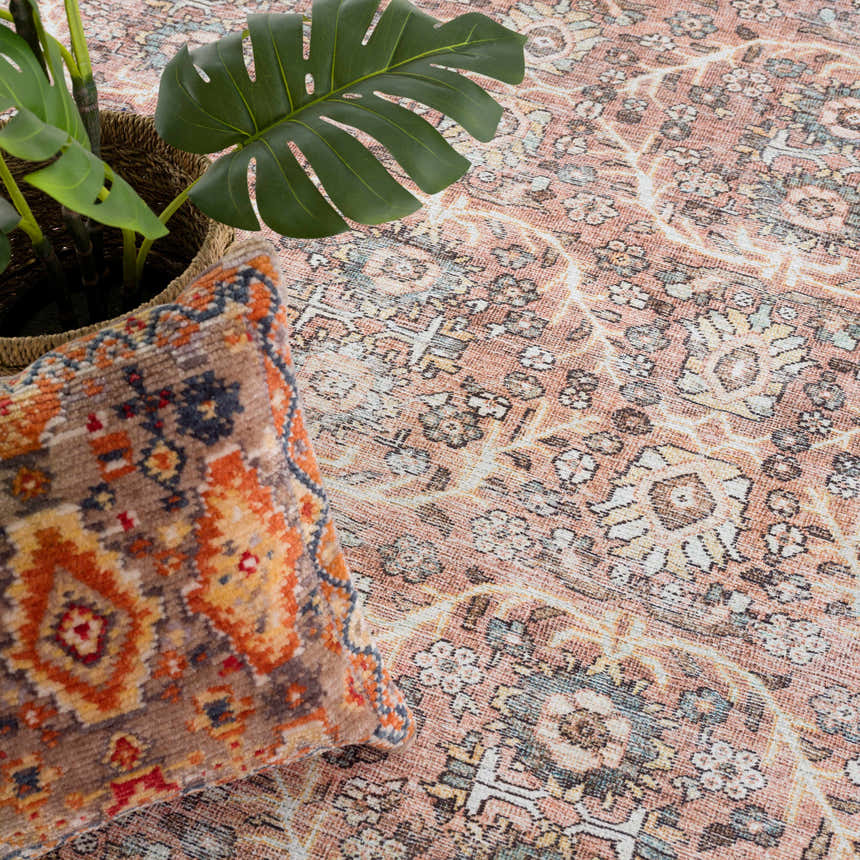 Close-up of the Flat Pile Urpi Red Washable Rug showing its vintage Persian design, peach tones, and soft texture. Styleshot