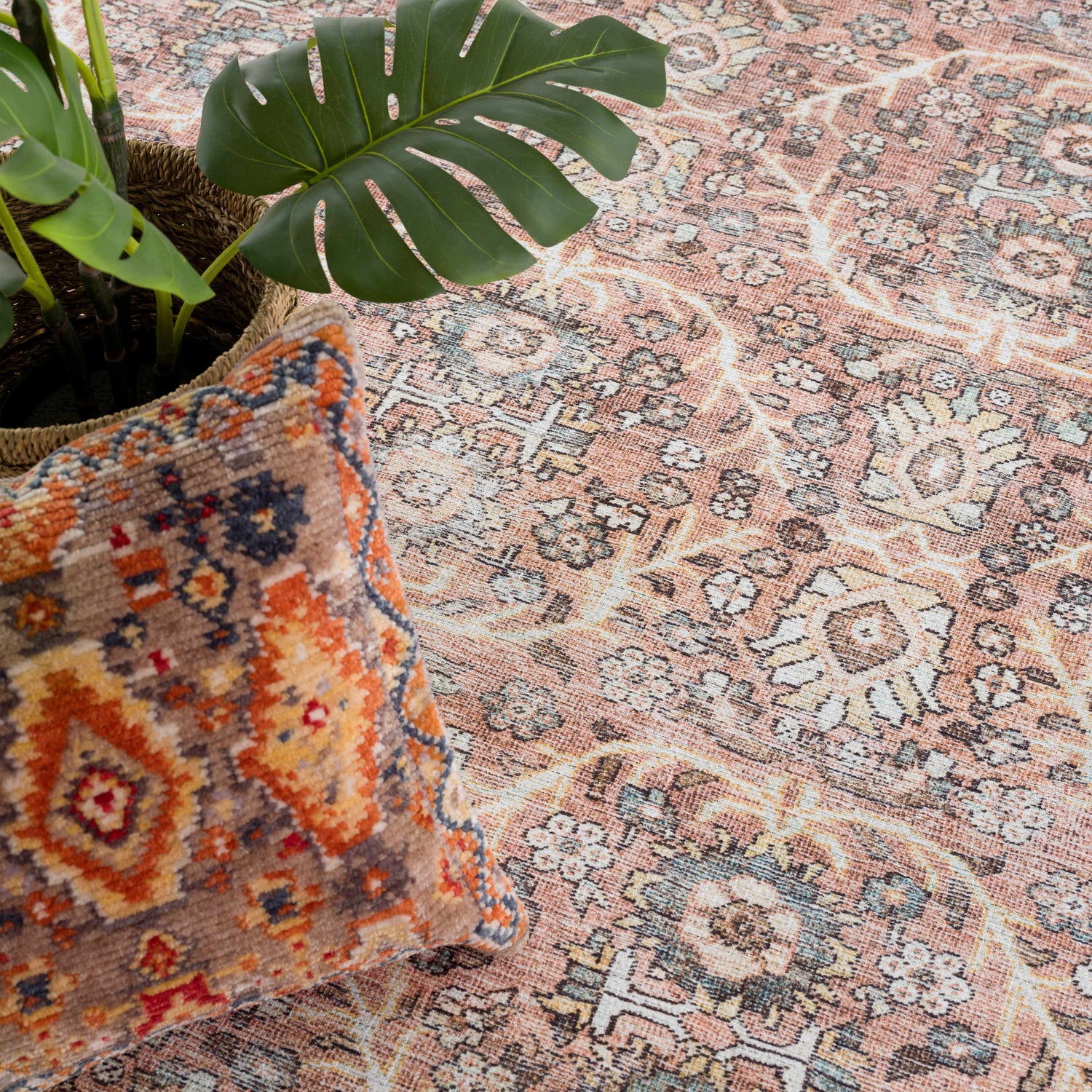Close-up of the Flat Pile Urpi Red Washable Rug showing its vintage Persian design, peach tones, and soft texture. Styleshot