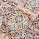 Close-up of the Flat Pile Urpi Red Washable Rug showing its Persian-style pattern and texture in red, beige, and brown tones. Texture