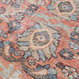 Close-up of the Konstantina Washable Area Rug showing a traditional Persian-style pattern in aqua, beige, and brown tones. Texture