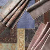 Overhead shot of multiple rolled and flat Maplesville Washable Area Rugs in beige, pink, teal, and plum colors. Farmhouse and traditional styles. Styleshot