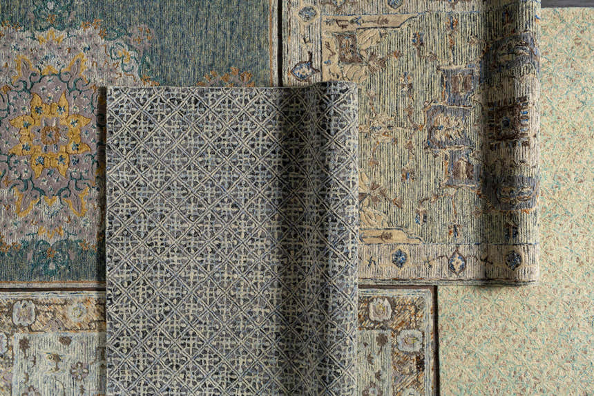 Close-up of multiple Lysander Area Rugs showing wool texture, blue, beige, brown, and sage color variations. Styleshot