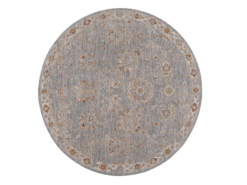 Close-up of a round Mangham Thick Luxe Area Rug. Features an oriental pattern in light gray, beige, and rust tones. Design-Round-67