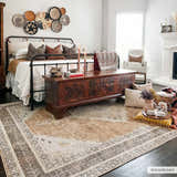 Bedroom scene with a dark brown Albas Washable Area Rug, wood chest, iron bed, and neutral decor for a traditional vintage style. Roomscene-Rectangle