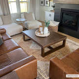 Living room with brown leather sofa and Albas Washable Area Rug in dark brown, light blue, and light brown tones. Roomscene-Rectangle