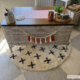 Styled desk with a round Alstead Shag Area Rug. Beige rug features a bold black plus sign pattern. Fun, cozy kids room decor. Roomscene-Round