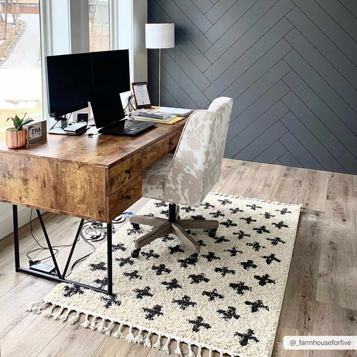 Home office with wood desk, patterned chair, and Alstead Shag Area Rug. The rug is beige with a black plus sign pattern. Roomscene-Rectangle