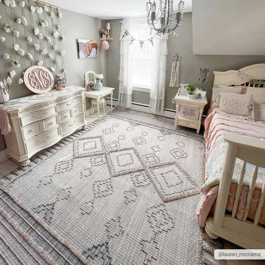 Light gray kids bedroom with white furniture and the Amaga High-Low Rustic Rug in charcoal, cream, and peach tones. Roomscene-Rectangle