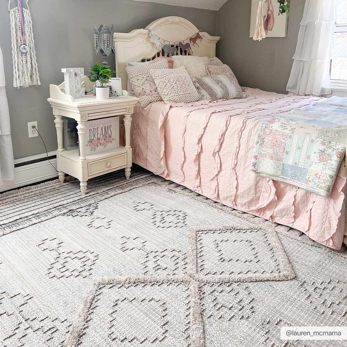 Light and airy bedroom with pink bedding and the Amaga High-Low Rustic Rug in cream and charcoal. Roomscene-Rectangle