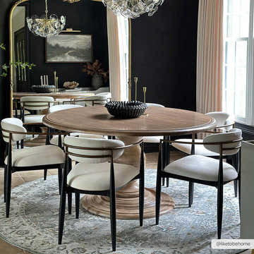 Dining room with round wood table on Amaru Green Textured Rug, black walls, and modern chandelier. Roomscene-Rectangle