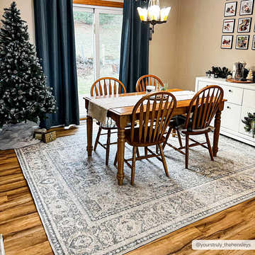 Farmhouse dining room with a Christmas tree and an Arias Boutique Washable Rug in beige and gray tones. Roomscene-Rectangle