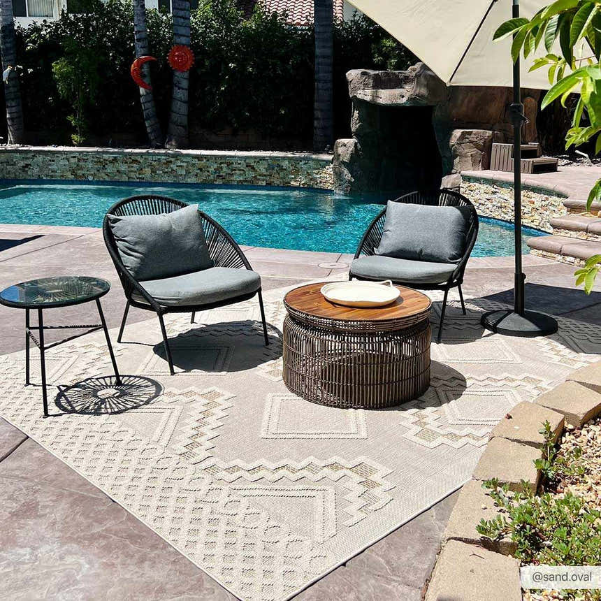 Outdoor patio scene with Arwid Bone Area Rug, chairs, and table by the pool. Contemporary style. Roomscene-Rectangle