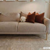 Living room scene with neutral sofa and the Ashra Thick Luxe Area Rug in cloud gray. Roomscene-Rectangle