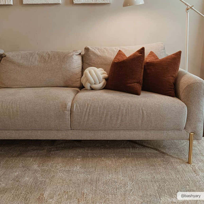 Living room scene with neutral sofa and the Ashra Thick Luxe Area Rug in cloud gray. Roomscene-Rectangle