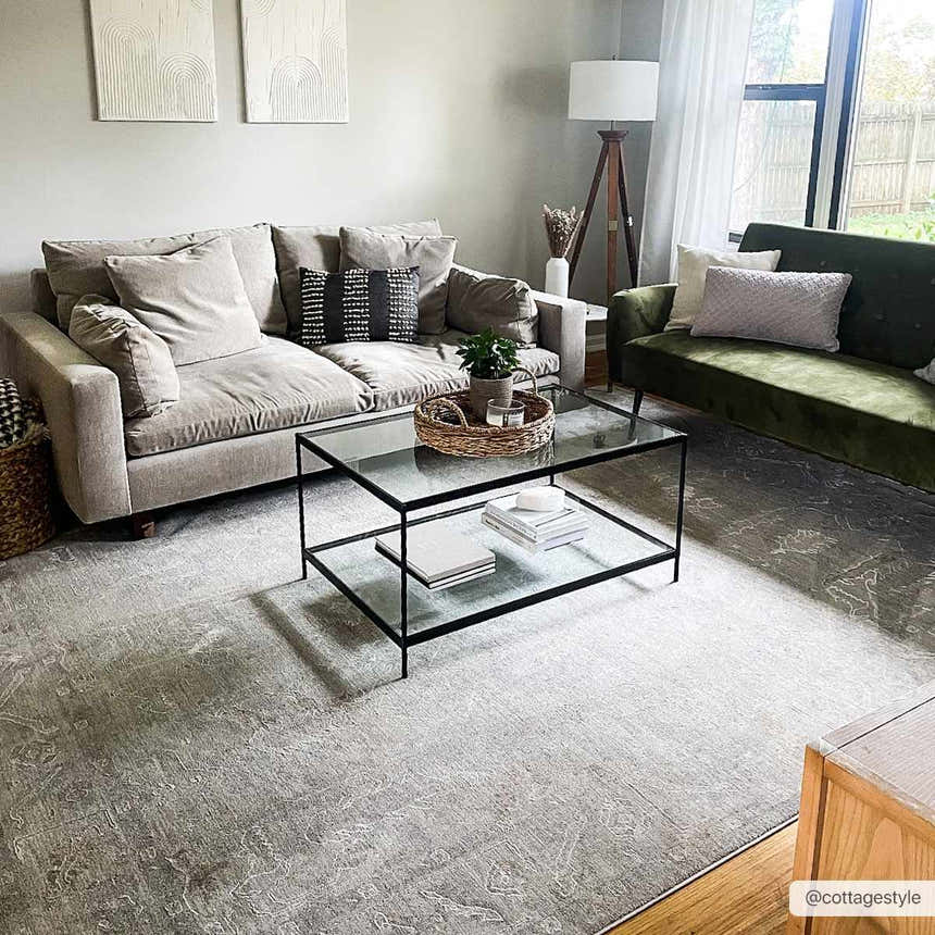 Living room scene with gray Ashra Thick Luxe Area Rug, neutral sofa, and glass coffee table. Farmhouse style. Roomscene-Rectangle