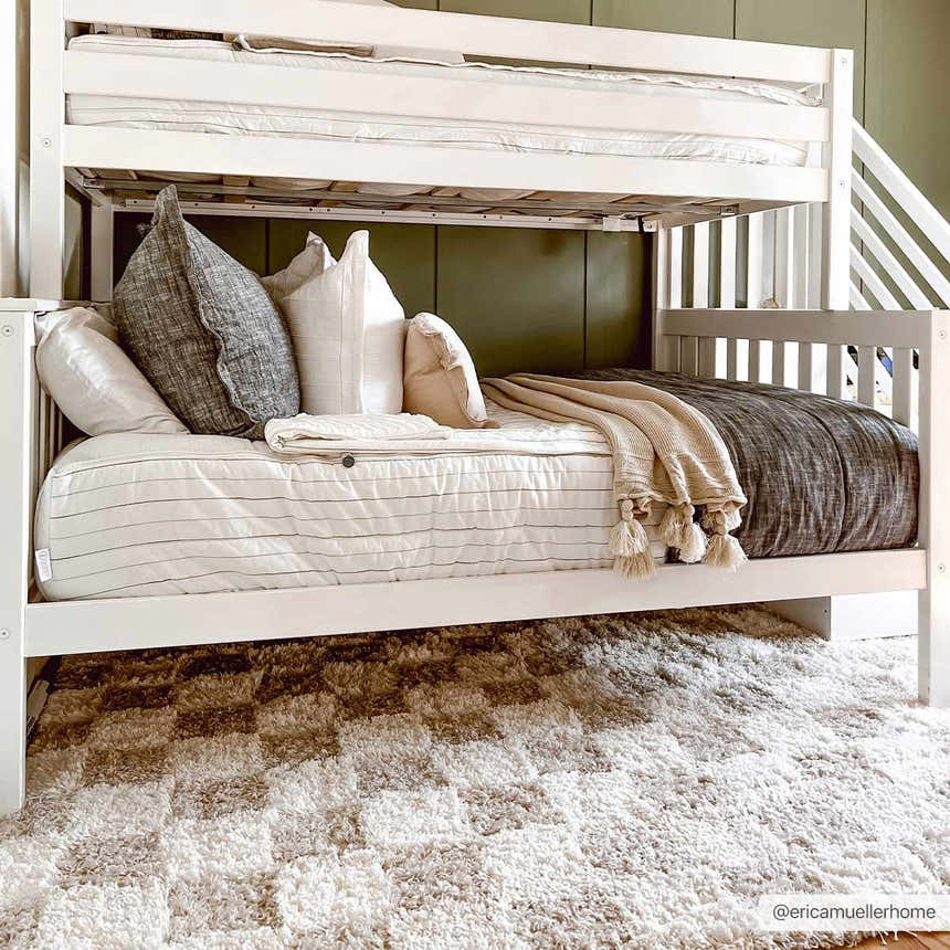 Kids room scene with white bunk bed and the Atira Light Brown Checkered Area Rug on the floor. Fold