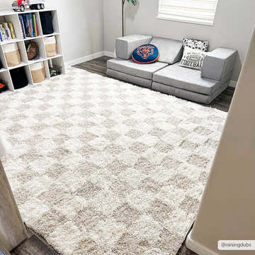 Kids room with Atira Light Brown Checkered Area Rug, gray modular sofa, bookcase, and football decor. Roomscene-Rectangle