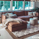 Living room scene with a plush cream rug and a brown sectional. The Atira Light Brown Checkered Area Rug adds texture to the neutral space. Roomscene-Rectangle