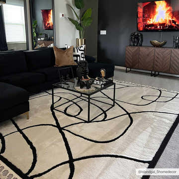 Living room scene with black sofa and Azana Black & White Area Rug. Modern decor, geometric pattern. Roomscene-Rectangle