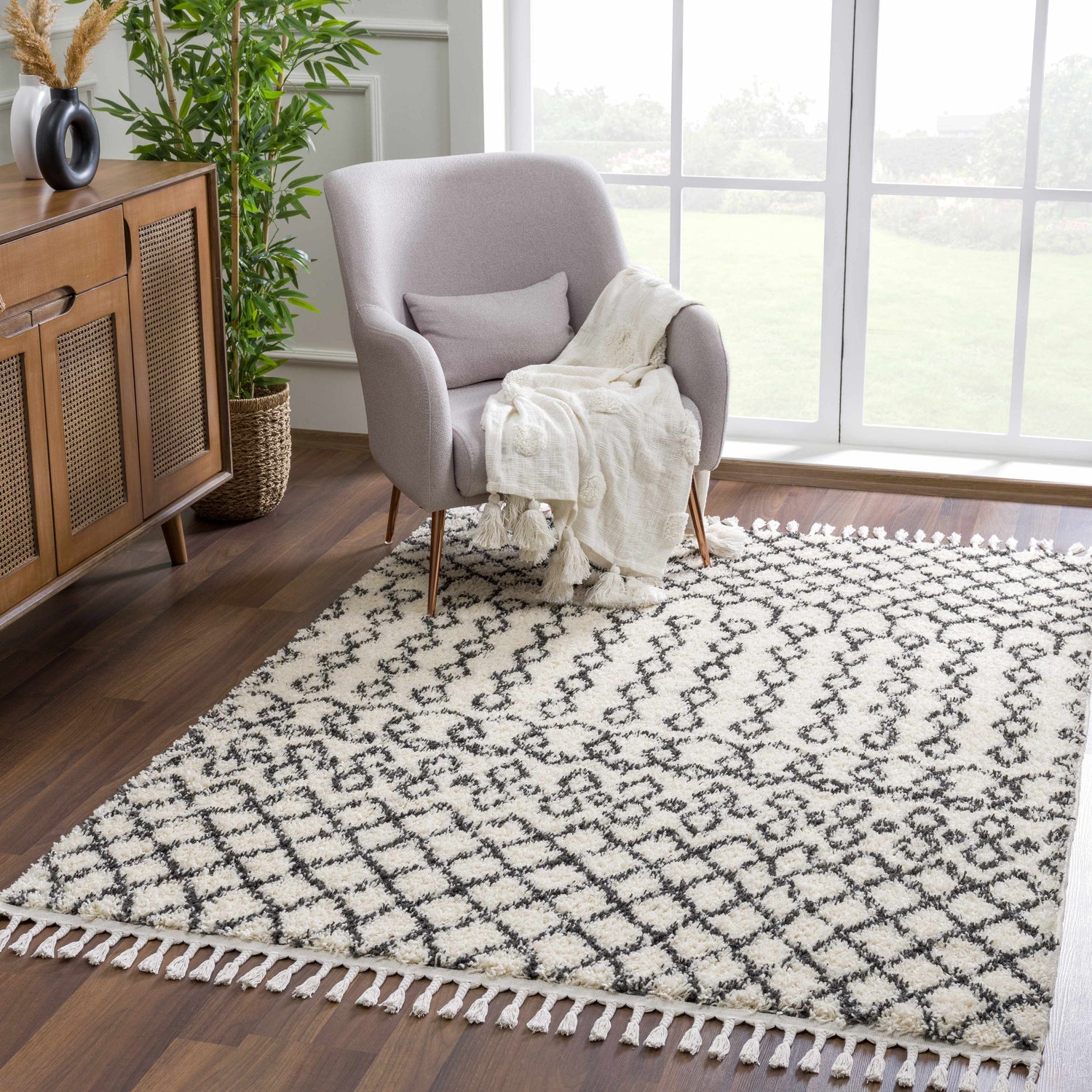 Living room scene with a Muni Berber Shag Rug, gray chair, wood cabinet, and bright window view. Roomscene-Rectangle