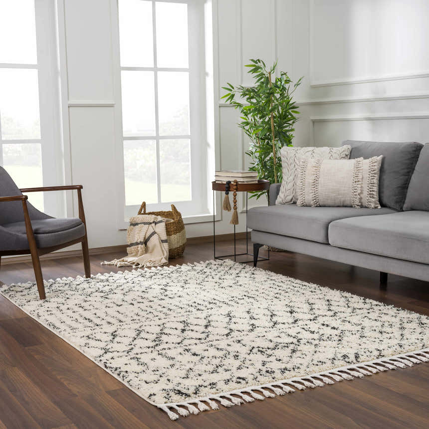 Living room scene with beige and charcoal Kibureau Area Rug, gray sofa, and wood accents. Roomscene-Rectangle