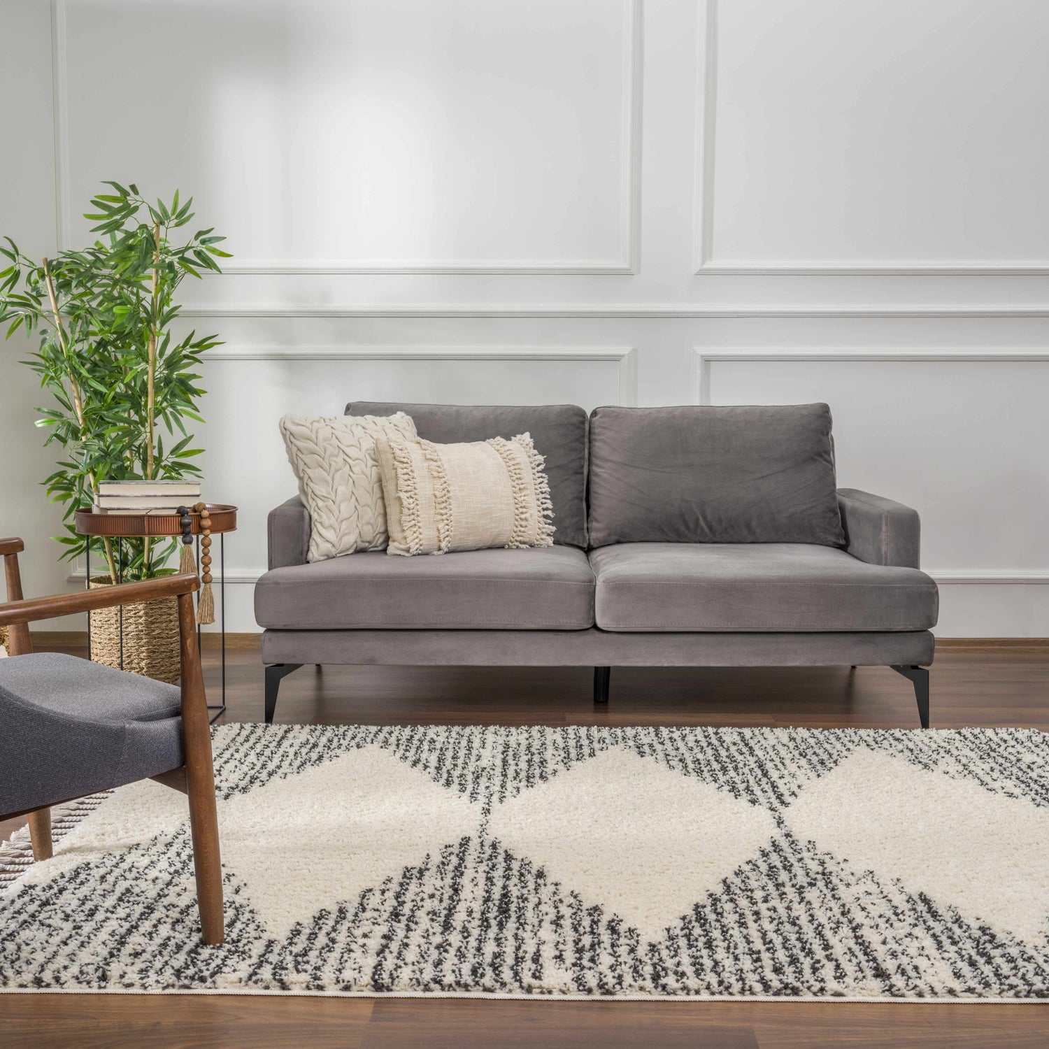 Living room scene with gray sofa, chair, and Howth Area Rug in bone and dark gray. Roomscene-Rectangle