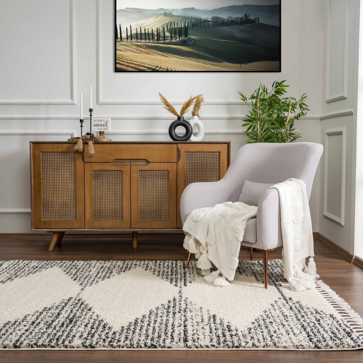 Living room scene with a bone and dark gray Howth Area Rug, light gray chair, and wood cabinet. Roomscene-Rectangle