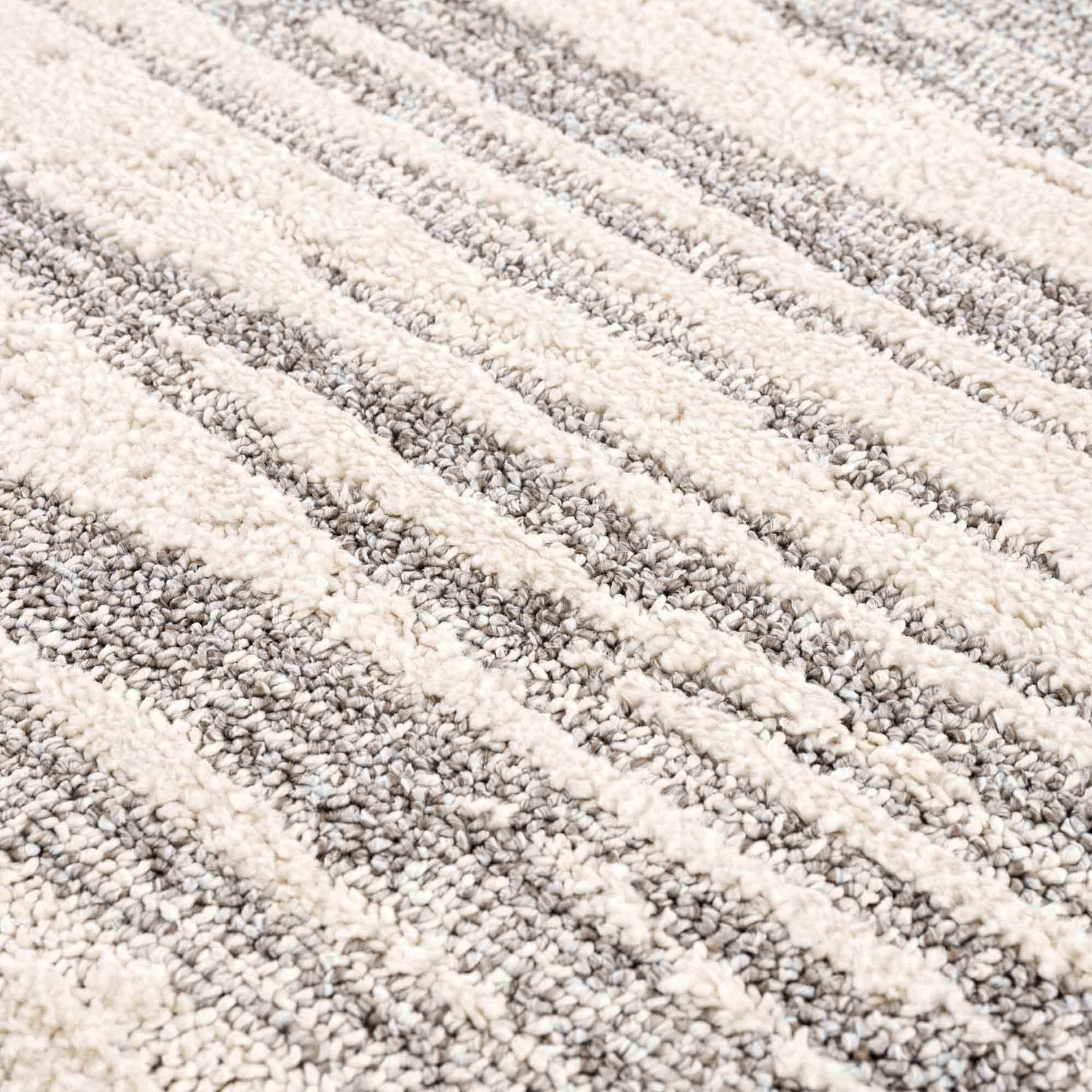 Close-up of the Lave Bone & Taupe Area Rug showing its plush texture and contemporary bone and taupe striped design. Texture