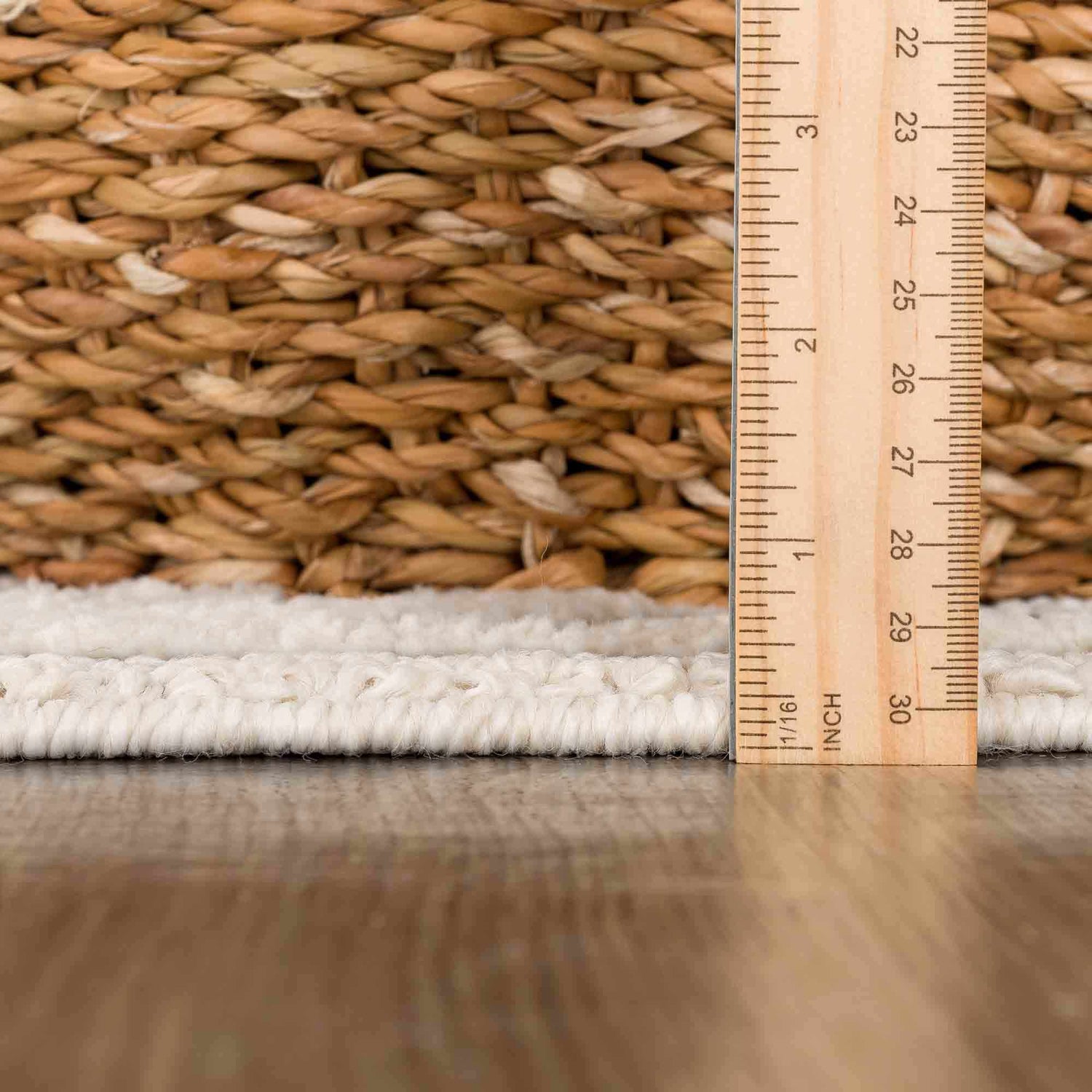 Close-up of the Umay Textured Beige Rug showing its pile height and woven texture with a ruler for scale. Pile