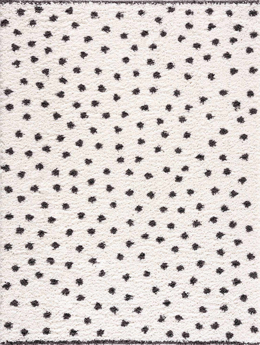 Close-up of the Chaia Dotted Black & White Plush Rug, featuring a soft texture and playful black polka dot pattern on a white base. Design-Rectangle-5373