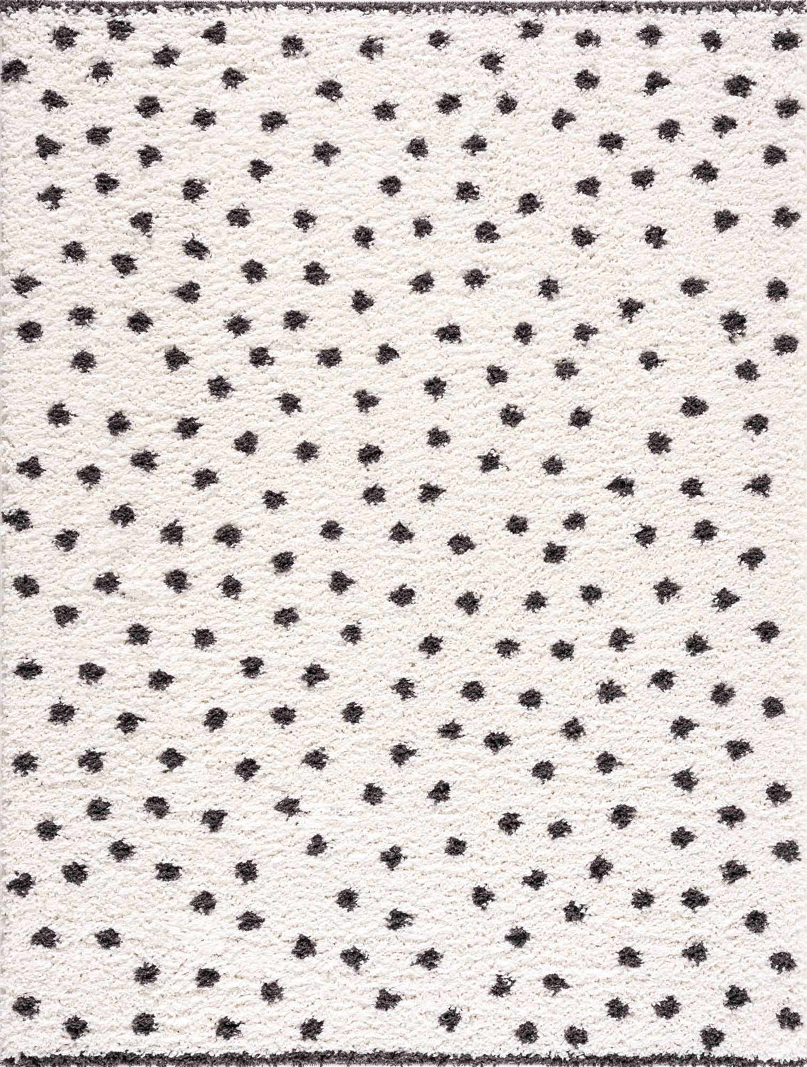 Close-up of the Chaia Dotted Black & White Plush Rug, featuring a soft texture and playful black polka dot pattern on a white base. Design-Rectangle-5373