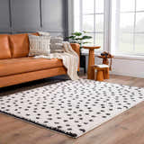 Living room with a brown leather couch and the Chaia Dotted Black & White Plush Rug. Roomscene-Rectangle