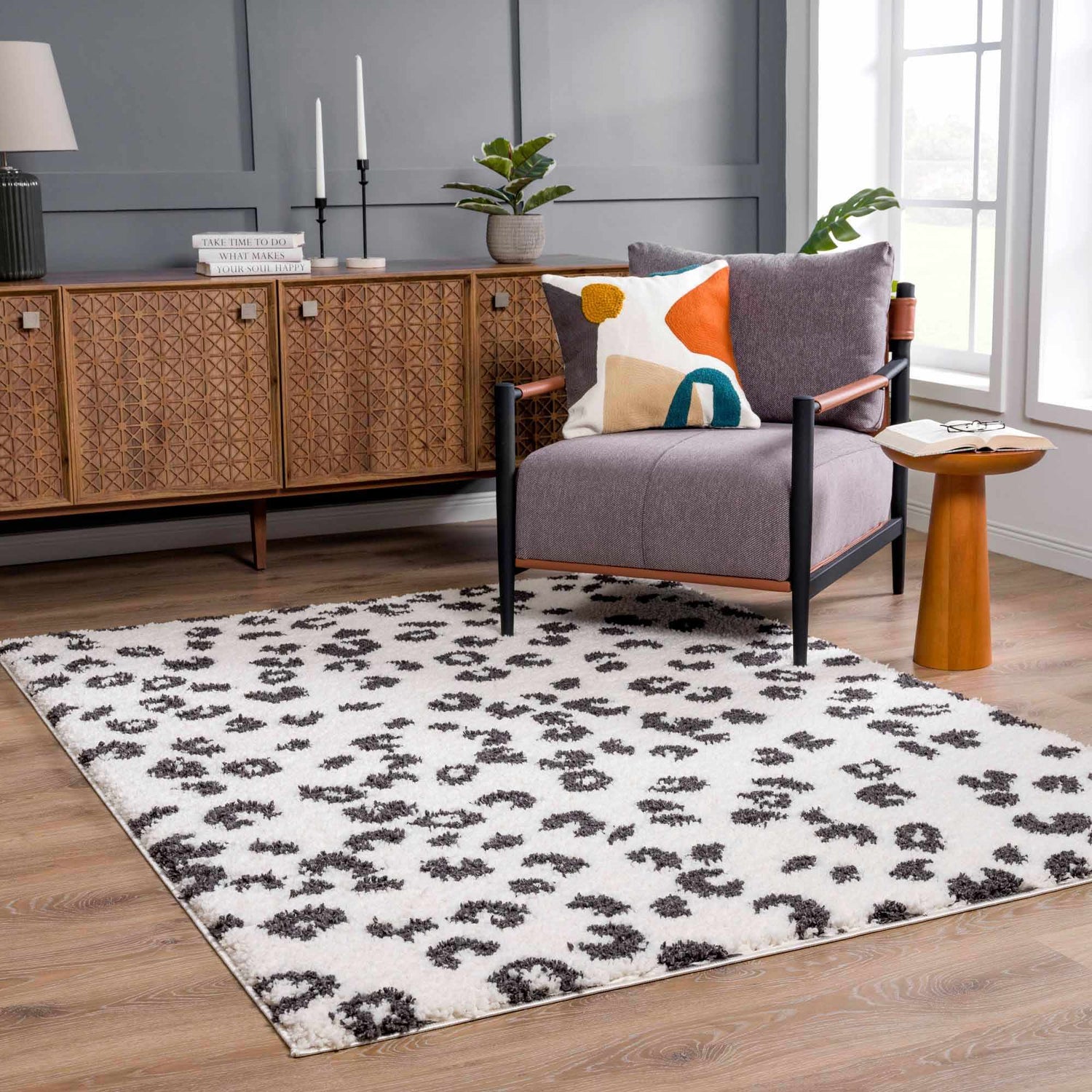 Living room scene with a Zhen Black Spots Leopard Rug, gray walls, and mid-century modern furniture. Roomscene-Rectangle