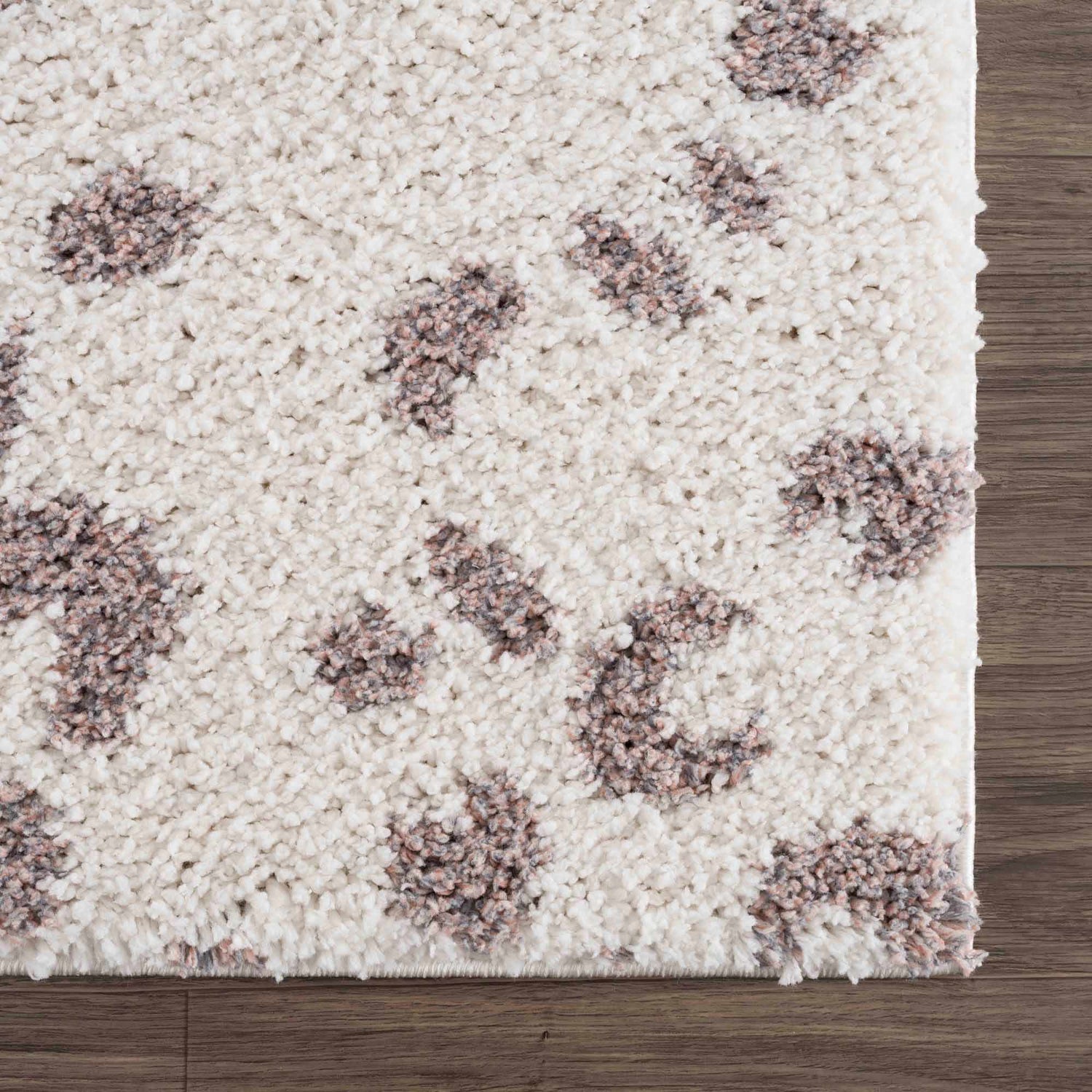Close-up of a Zhen Pink Spots Leopard Rug showing its shaggy texture and brown, off-white, and pink leopard spots. Swatch