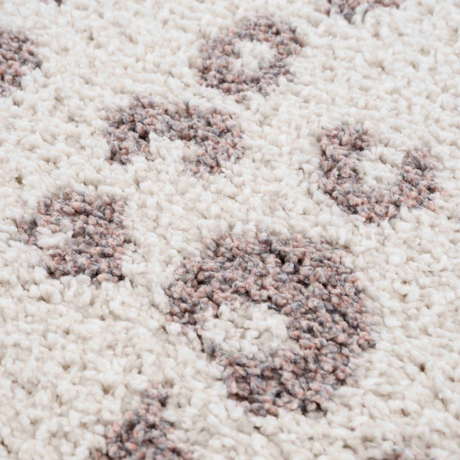 Close-up of the Zhen Pink Spots Leopard Rug showing the shag texture and pink and brown leopard spot pattern on off-white. Texture