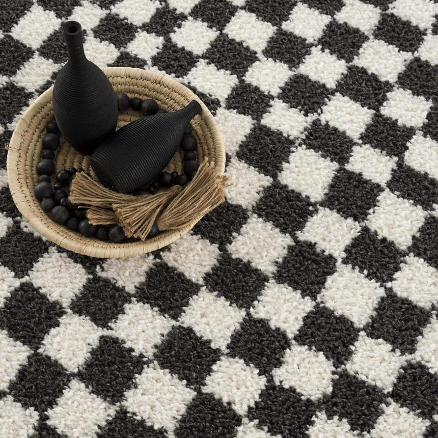 Close-up of the Kieu Black & White Checkered Shag Rug, a plush rug with a bold geometric pattern and soft texture. Styleshot