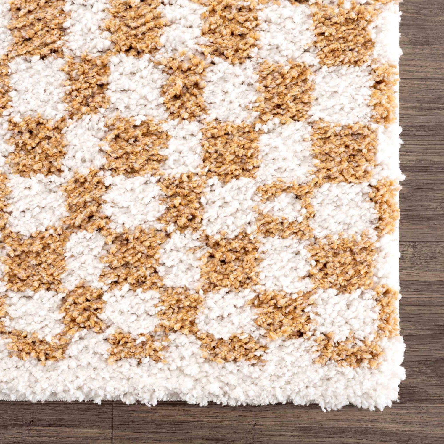 Close-up of the Kieu Mustard & Ivory Checkered Area Rug. Shag rug with a geometric checkered pattern in mustard and ivory. Swatch