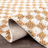Close-up of the Kieu Mustard & Ivory Checkered Area Rug showing the shag texture and checkered pattern. Fold