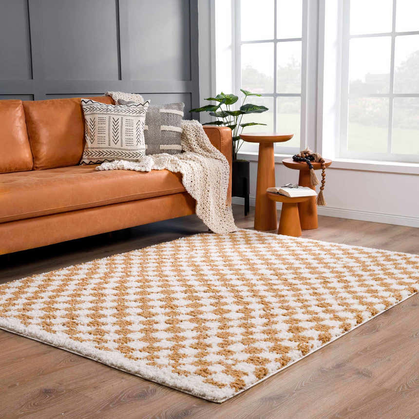 Living room with tan leather sofa and Kieu Mustard & Ivory Checkered Area Rug on wood floor. Modern bohemian style. Roomscene-Rectangle