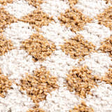 Close-up of the Kieu Mustard & Ivory Checkered Area Rug, showing the shag texture and geometric pattern. Texture