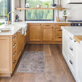 Dusty sage and navy Burstwick Thick Luxe Boutique Rug in a bright, modern kitchen with wood cabinets and white countertops. Roomscene-Rectangle