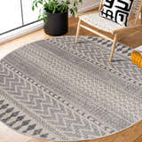 Round Tigri Aztec Ivory & Gray 2311 Rug in a cozy reading nook with a chair, plant, and wood floors. Roomscene-Round
