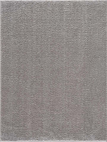 Close-up of the Judy Solid Gray Washable Shag Rug, showing its soft, textured pile and light gray color. Design-Rectangle